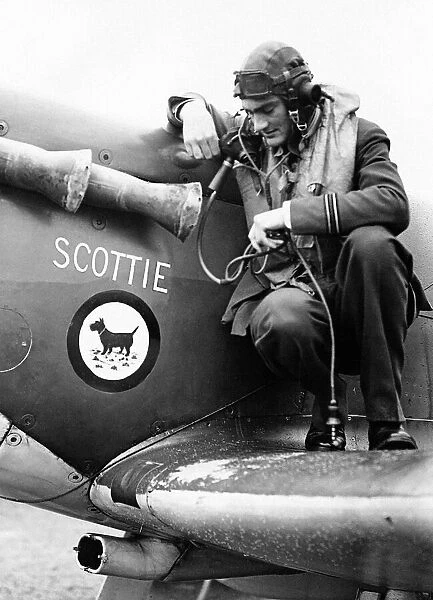 An RAF spitfire pilot of 603 Squadron inspects identity crest