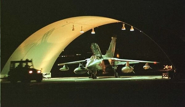 An RAF Tornado GR1 jet being prepared for battle in the hangar at Ali Al Salem Air Base