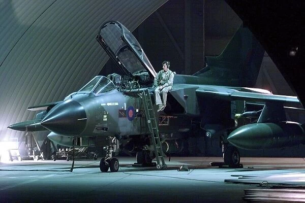 An RAF Tornado jet being prepared for battle in the hangar at Ali Al Salem Air Base in