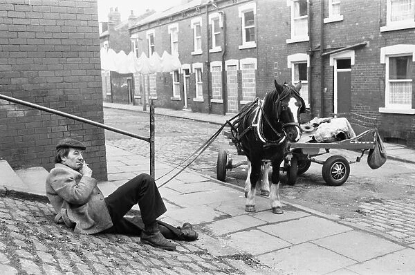 A rag and bone man and his horse and cart seen here taking rest from travelling