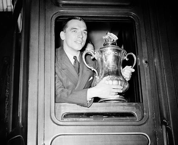 Raich Carter, captain of Sunderland football team, holding the FA Cup