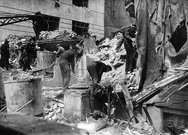 Raid Damage, London. ARP and Heavy Rescue personnel searching the debris for victims