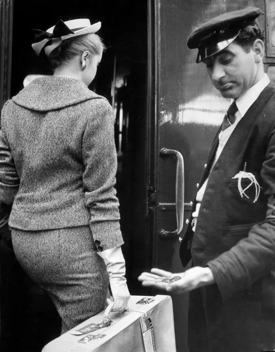 Framed Print : A Railway porter look down at the meager tip given to him by a woman passenger after Framed Print : A Railway porter look down at the meager tip given to him by a woman passenger after