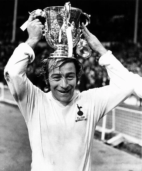 Ralph Coates of Tottenham Hotspur holding the League Cup trophy on his head after Spurs