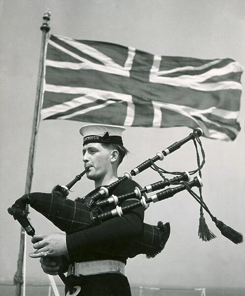 A rating aboard the Royal Navy aircraft carrier HMS Illustrious practising the bagpipes