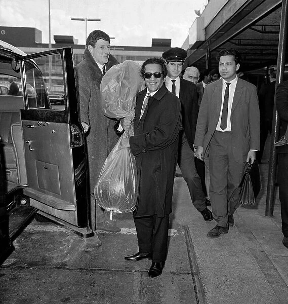 Ravi Shankar arriving at London Airport from Bombay his sitar is enclosed in a polythene