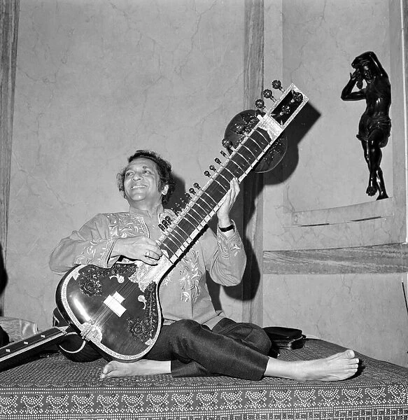 Ravi Shankar bare footed, plays his sitar at the Hyde Park Hotel