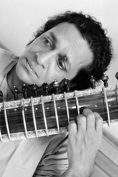 Ravi Shankar playing the sitar in his suite at the Savoy Hotel. October 1969