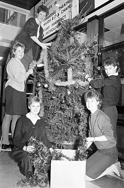 Rawthorpe High School pupils decorating the Christmas Tree in the entrance to St Luke