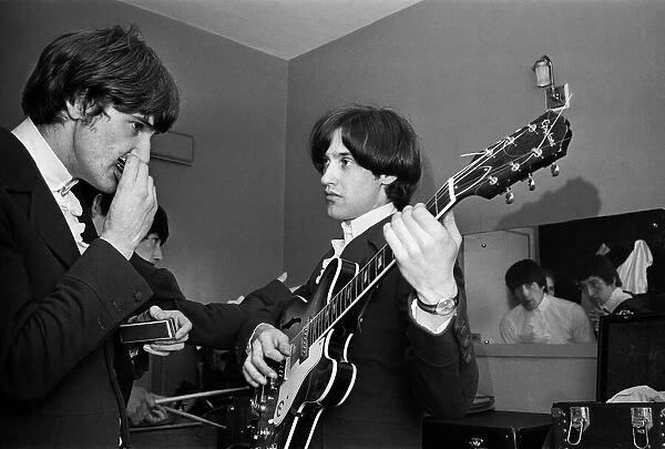 Ray Davies and Dave Davies of The Kinks pop group rehearsing in their dressing room