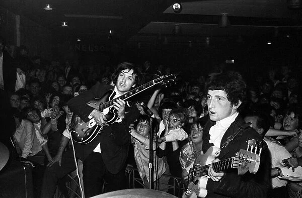 Ray Davies and Dave Davies of The Kinks pop group on stage during a concert