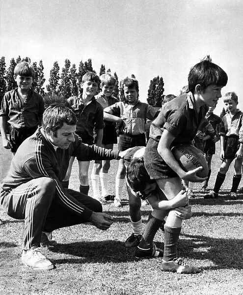 Ray Williams, WRU coaching organiser, and youngsters at a coaching session. Circa 1973