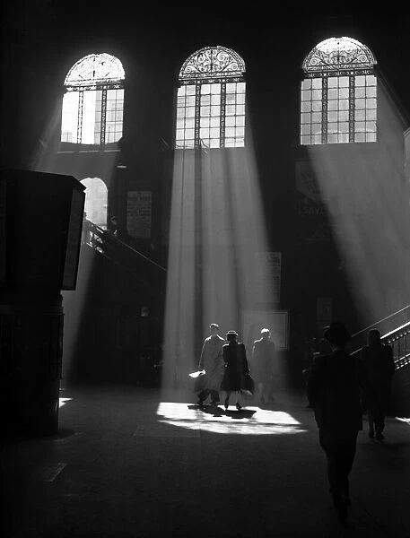 Rays of sunlight entering Londons Liverpool Street railway station through the high