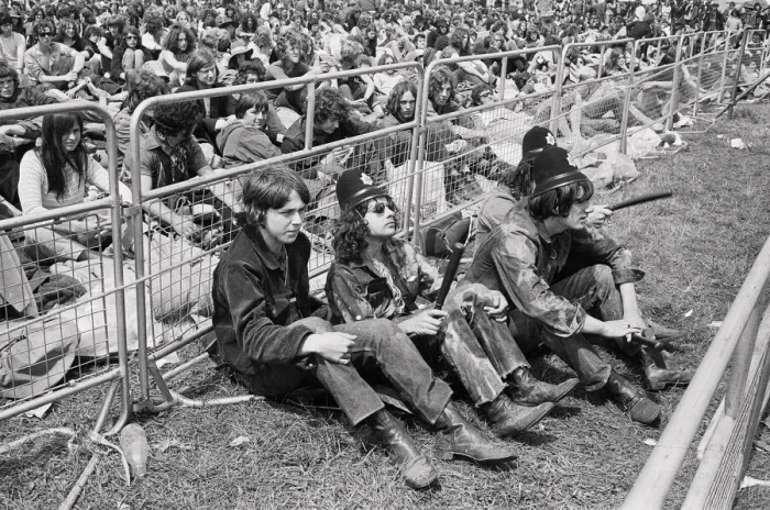 Framed Print : Reading Pop Festival. Music fans wearing police helmets