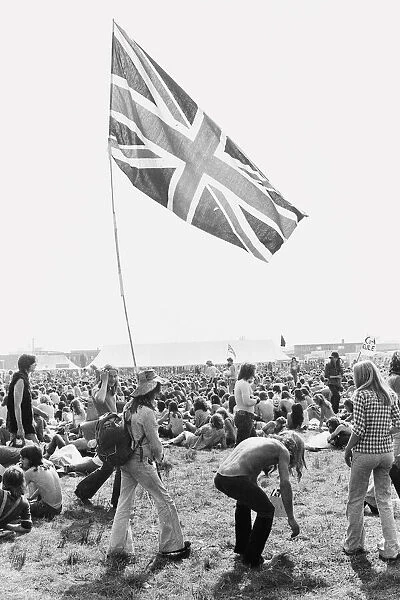 Reading Pop Festival. Young festival goers carrying the Union Jack flag as they
