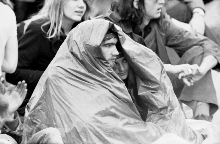 Framed Print : Reading Pop Festival. Young festival goers take cover from the rain under make Framed Print : Reading Pop Festival. Young festival goers take cover from the rain under make