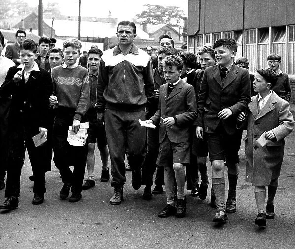 Former Real Madrid player Ferenc Puskas surrounded by Kilmarnock schoolchildren asking
