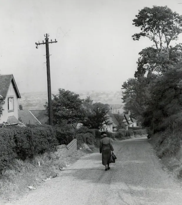 Framed Print : Rear view of a woman walking down a rural country lane near West Bromwich in the West