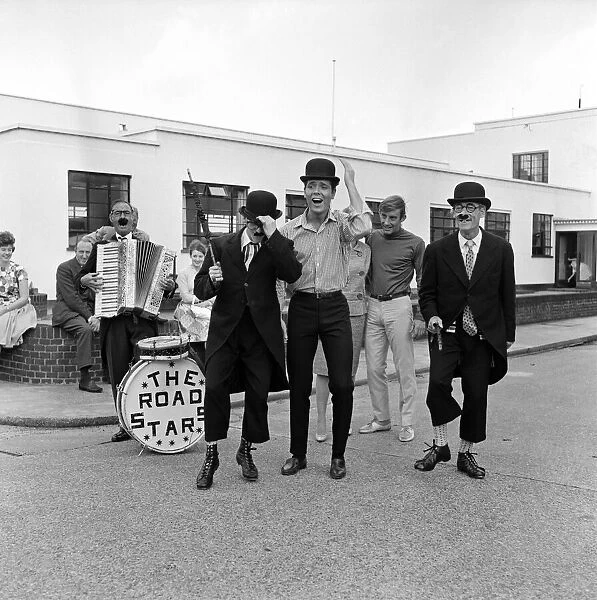 Recognise the bowler-hatted 'busker'? Its Cliff Richard