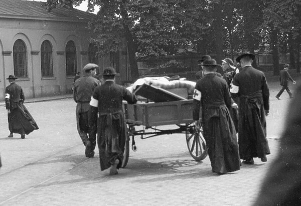 Red Cross priests conveying wounded on cart to hospital Circa August 12th 1914