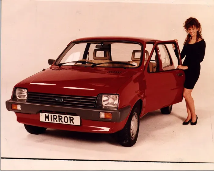 Framed Print : RED METRO MODEL STANDING NEXT TO CAR COMPETITION PRIZE MINI METRO Framed Print : RED METRO MODEL STANDING NEXT TO CAR COMPETITION PRIZE MINI METRO