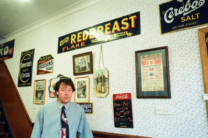 Framed Print : Redcar barber Mike Forbes with some of his collection of memorabilia in his shop Framed Print : Redcar barber Mike Forbes with some of his collection of memorabilia in his shop