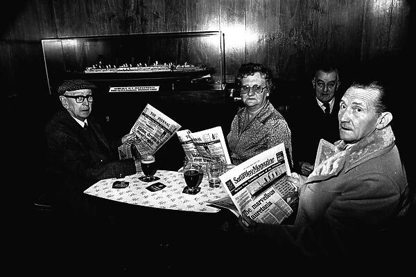 Four regulars at the Mauretania Pub in Wallsend, reading a copy of the Newcastle Journal