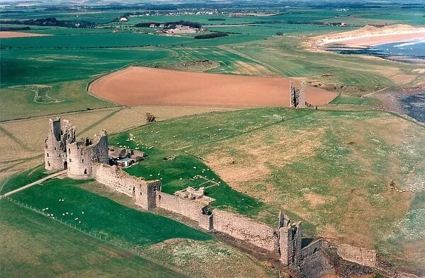The remote and impressive ruins of Northumberlands Dunstanburgh Castle in July 1999