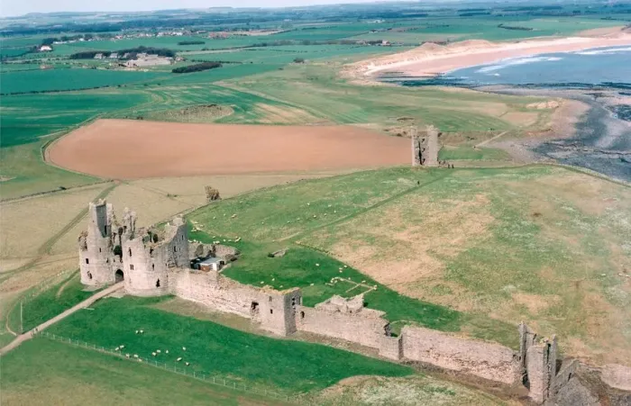 Framed Print : The remote and impressive ruins of Northumberlands Dunstanburgh Castle in July 1999
