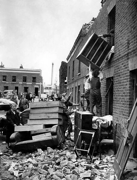 Removing furniture from a top room in Deptford. June 1944 P009362