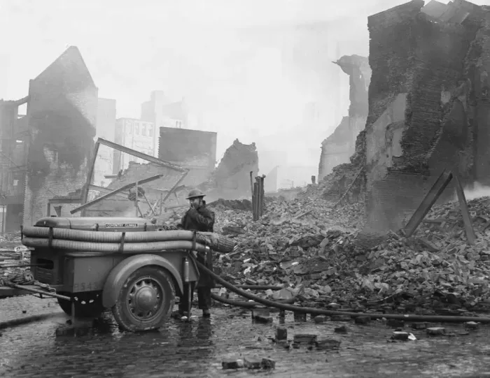Framed Print : A rescue worker operating a Coventry Climax fire pump admist the shroud of smoke
