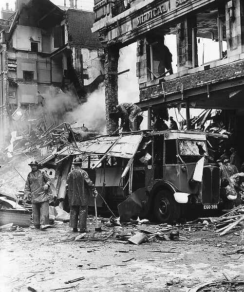 Rescue workers clear a London double decker bus damaged by the blast from a bomb during