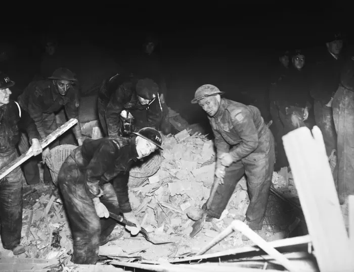Framed Print : Rescue workers dig through the rubble after a V2 missile exploded at the junction of Framed Print : Rescue workers dig through the rubble after a V2 missile exploded at the junction of