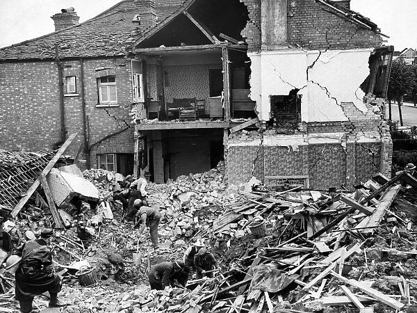 Rescue workers looking for survivors following a Nazi raid, Alric Avenue, New Malden