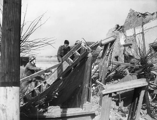 Rescue workers search the rubble of Audrey Road, Ilford, following a V2 missile attack