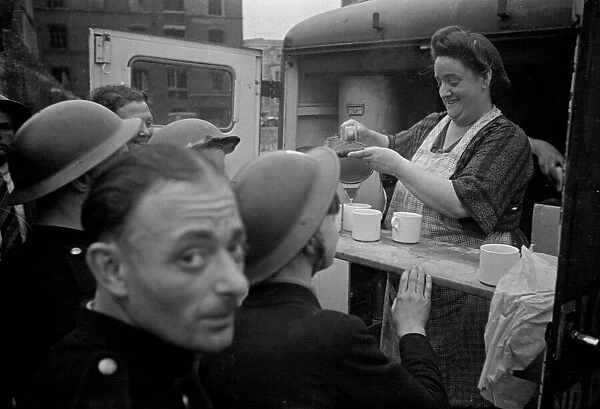 Rescue workers are served tea from a mobile naffi following the V1 bombing of Brown
