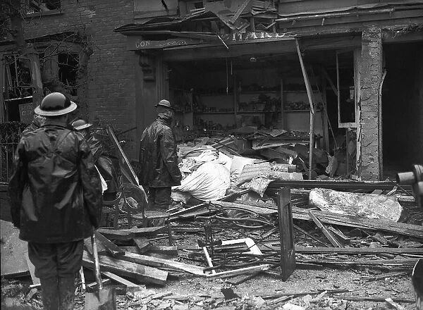Rescuers looking through bomb damaged building during WW2