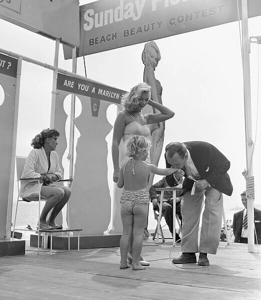 Resident Compere Steve Conway gallantly greets Linda, daughter of pictorial beach contest