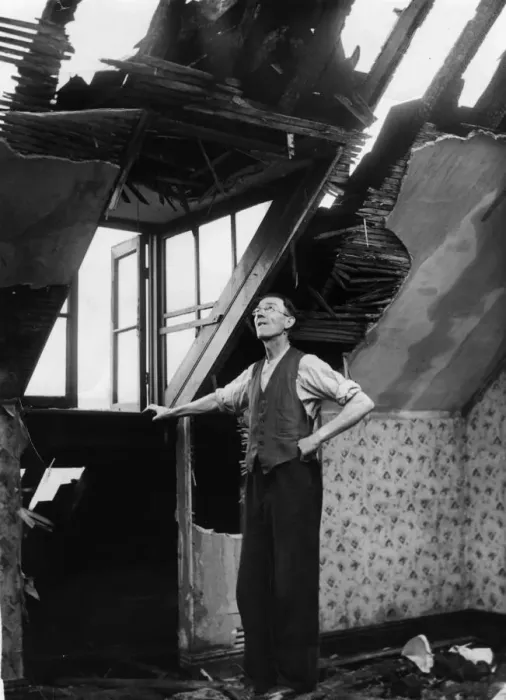Framed Print : A resident of an East Yorkshire town surveys the damage to his home caused by a German