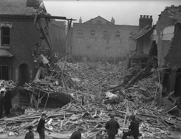 Resident gather around the rubble of a house in Knowle Road, Birmingham