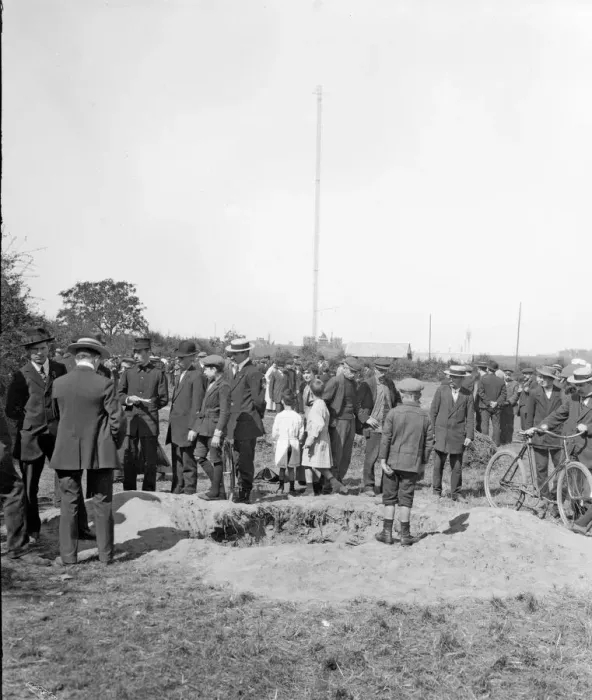 Framed Print : Residents of Antwerp inspect one of the craters made as a result of one of the three air