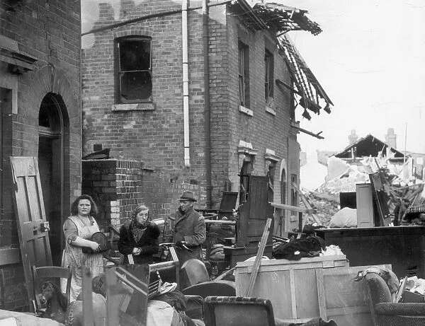 Residents of a Coventry street stand outside their ruined homes after the city was