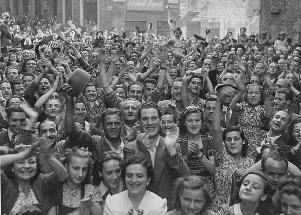 Residents of the Italian town of Siena cheering and celebrating as French troops of