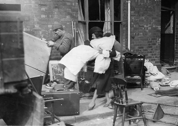 Residents of a residential are of Cardiff, Wales salvage goods from their homes after it