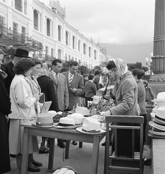 Residents of the Soviet city of Yalta looking at hats for sale on a market stall in