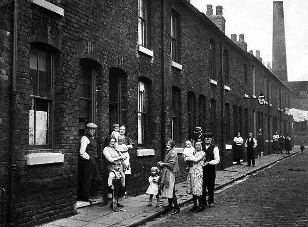 Some of the residents in a street in Pendleton, Greater Manchester. July 1932