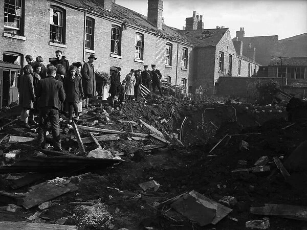 Residents of Vincent Street Balsall Heath, Birmingham, examine a bomb crater following an