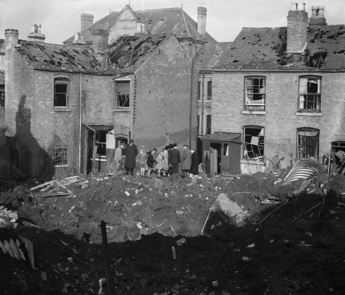 Framed Print : Residents of Vincent Street Balsall Heath, Birmingham, examine a bomb crater following an Framed Print : Residents of Vincent Street Balsall Heath, Birmingham, examine a bomb crater following an