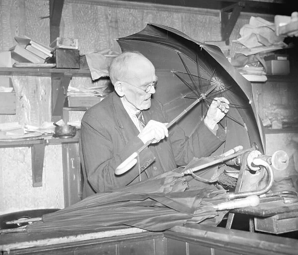 Rev D Smith repairing umbrellas in 1941