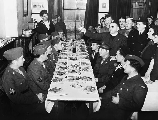 Rev. M. Goodman raises the Kiddush Cup to Jewish troops at a Kosher meal